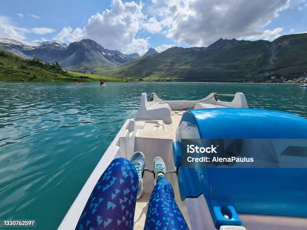 Woman Enjoying Paddleboat On The Lake Tignes Pov Stock Photo - Download Image Now - Paddleboat, Pedal Boat, Blue