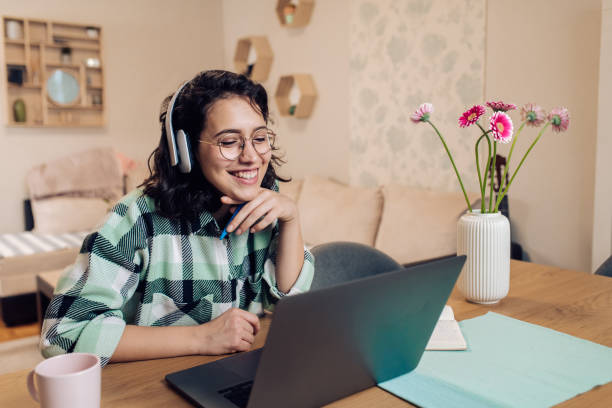 istock Girl having an online class at her home office 1330762653