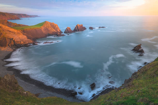 hartland quay, england - devon north devon sunset multi colored stock-fotos und bilder