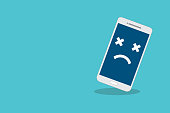Broken smartphone with sad smile. Broken phone service, recovery and repair concept, symbol top view copy space.