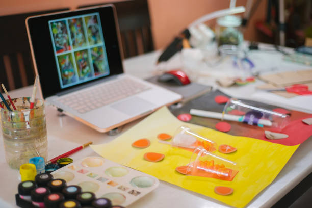 istock Video conference laptop and art tools preparing on desk during online art class in home 1330763470