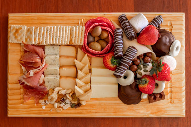 istock Cheese table with serrano ham, cookies, nuts, strawberries and chocolate 1330763599