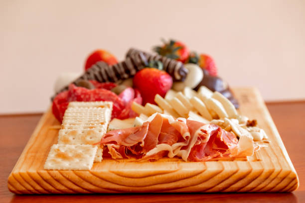 istock Cheese table with serrano ham, cookies, nuts, strawberries and chocolate 1330763620