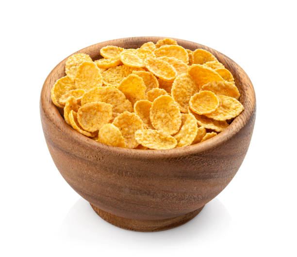istock Wooden bowl of corn flakes isolated on white background 1330765006