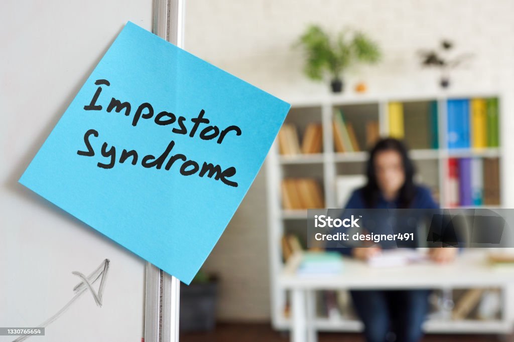 Impostor syndrome written on the sticker on the whiteboard. Impostor syndrome written on sticker on the whiteboard. Imitation Stock Photo