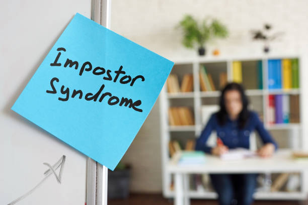 Impostor syndrome written on the sticker on the whiteboard. Impostor syndrome written on sticker on the whiteboard. imitation stock pictures, royalty-free photos & images