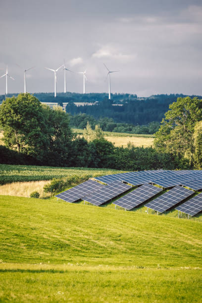 istock Solar Panels In A Green Field 1330765856