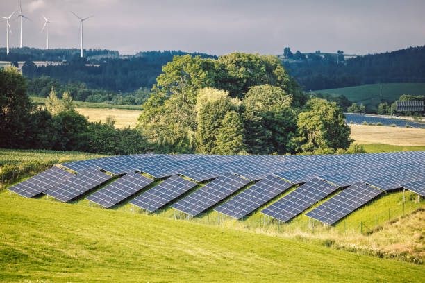 istock Solar Panels In A Green Field 1330765858