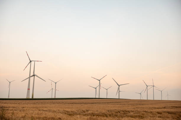 istock Spinning Wind Turbines In An Empty Field In Germany 1330766096