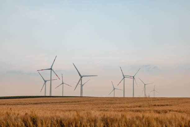 istock Spinning Wind Turbines In An Empty Field In Germany 1330766151