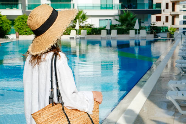 istock Young woman by the pool 1330768377