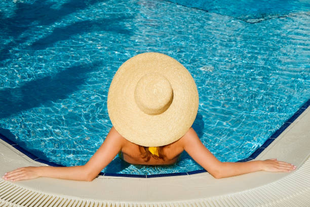 istock Young woman by the pool 1330768425
