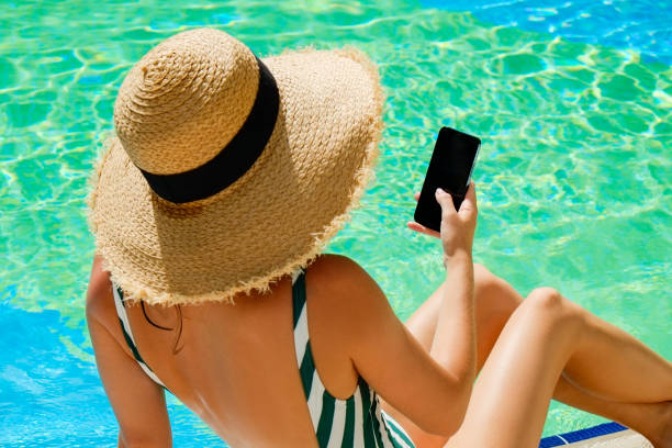 istock Young woman by the pool 1330768437