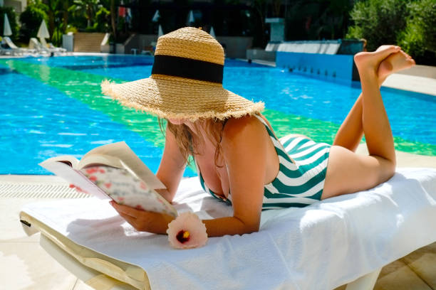 istock Young woman by the pool 1330768449