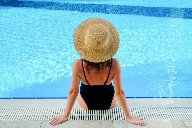 istock Young woman by the pool 1330768464