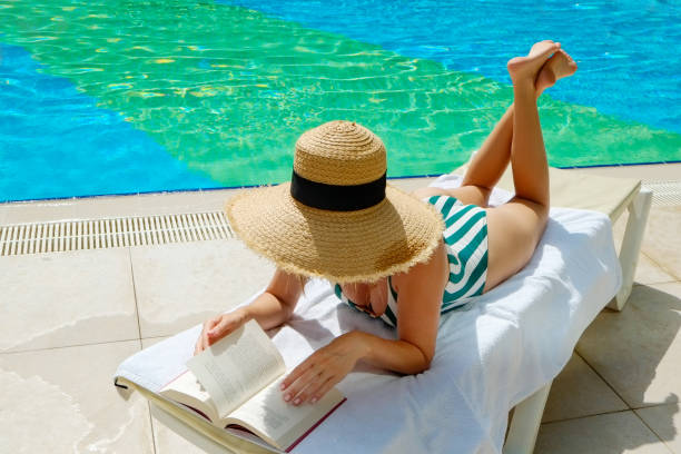 istock Young woman by the pool 1330768481