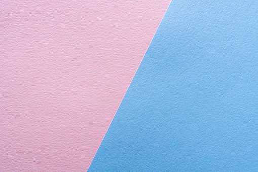 Background of two parts of colored paper pastel blue and pink, devided  by a sloping border.
