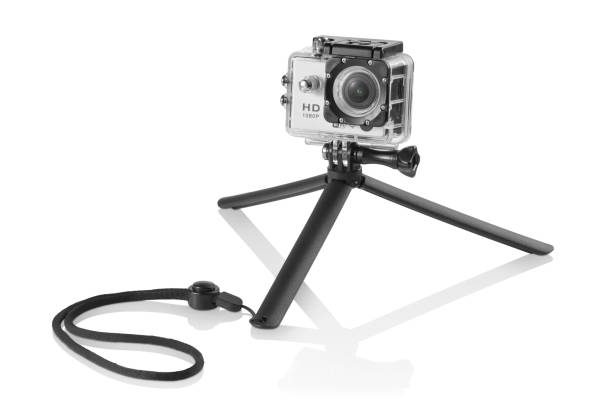 Black plastic mini tripod with a silver action camera on top Black plastic mini tripod with a silver action camera on top inside a waterproof box on white background with reflection underneath bicycle docking station stock pictures, royalty-free photos & images