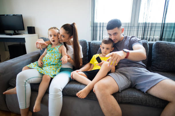 istock Family with two childrens watching tv 1330770039
