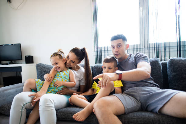 istock Happy family watching tv show 1330770047