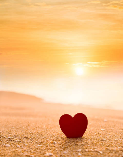 istock Red heart shape on the beach at sunset 1330774860