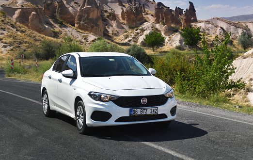 White Fiat Tipo on the highway in the mountains of Cappadocia. Fiat Tipo is a compact car produced by Fiat since 2015.