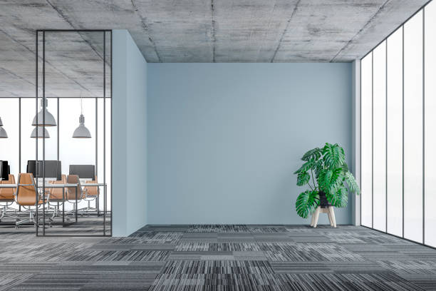 istock Empty office interior: a lounge corner with copy space and wordesks behind glass door 1330775290