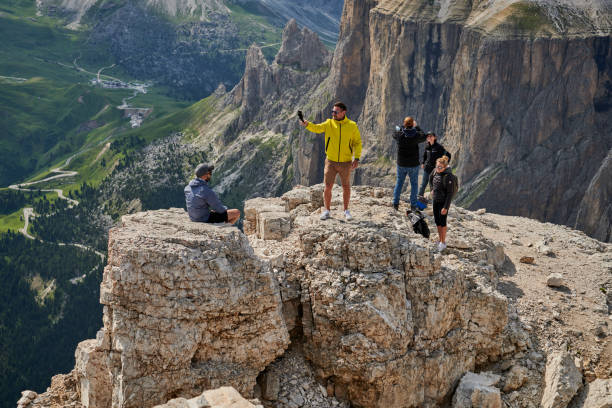 Tourists on the plateau Terrazza Delle Dolomiti Passo Pordoi in the Italian Dolomites. July 20 - 2021. People are hiking during summer at an altitude round 2950 meter over sea level. The glaciers are melting and leaving the mountain uncovered during summertime. Image from Northern Italy green valley denmark stock pictures, royalty-free photos & images
