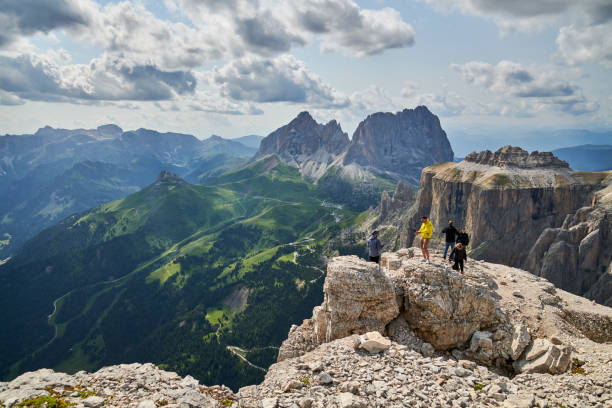 Tourists on the plateau Terrazza Delle Dolomiti Passo Pordoi in the Italian Dolomites. July 20 - 2021. People are hiking during summer at an altitude round 2950 meter over sea level. The glaciers are melting and leaving the mountain uncovered during summertime. Image from Northern Italy green valley denmark stock pictures, royalty-free photos & images