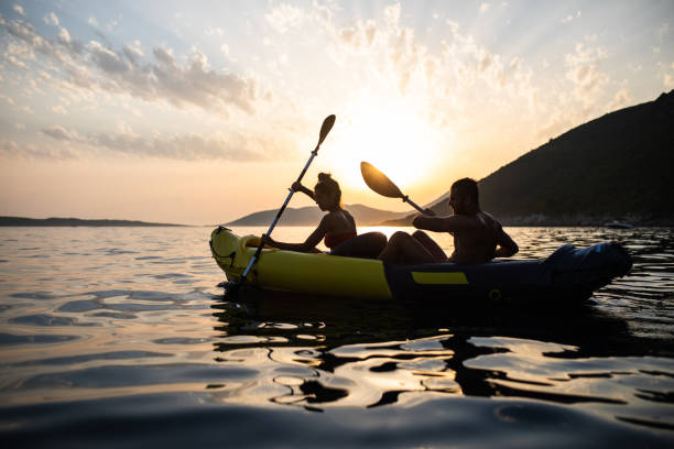 istock An active couple rowing a kayak at sunset 1330776176