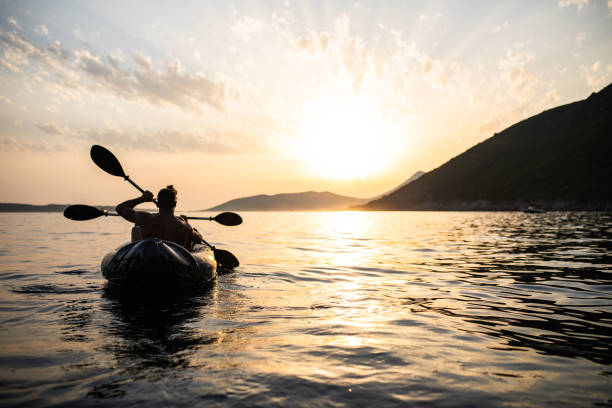 istock A couple rowing an kayak into the sunset 1330776191
