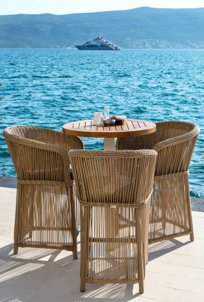 istock Table with chairs at cafe on seashore. 1330777365