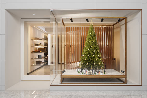 exterior of clothing store with christmas tree, ornaments and gift boxes displaying in showcase - christmas shopping imagens e fotografias de stock
