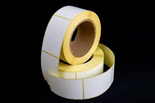 istock Blank Label Stickers. White roll of labels for thermal perforation. Sticky label roll 1330780732