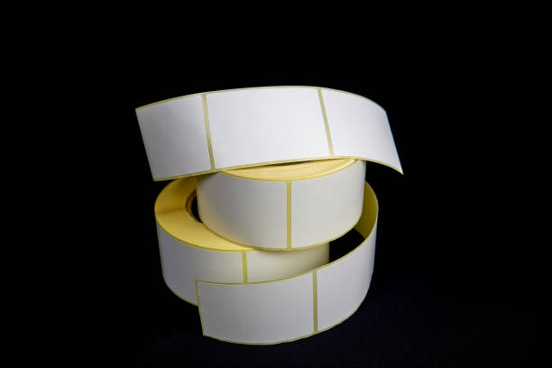 istock Blank Label Stickers. White roll of labels for thermal perforation. Sticky label roll. 1330780774