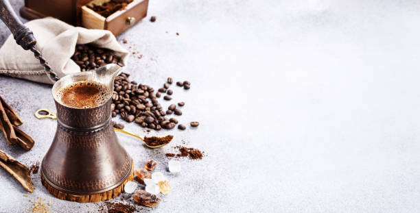 Turkish coffee brewing pot and beans on concrete with copy space Turkish coffee brewing pot and beans on concrete background with copy space cezve stock pictures, royalty-free photos & images