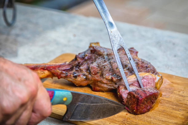istock A man cuts cooked fried meat on a cutting board. Oven-baked meat for dinner. 1330785270