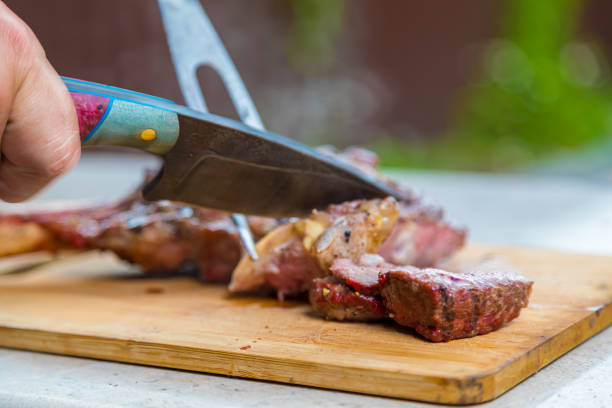 istock A man cuts cooked fried meat on a cutting board. Oven-baked meat for dinner. 1330785280