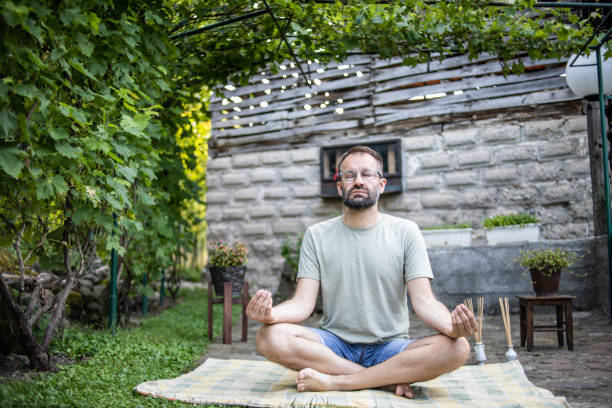 istock A man doing yoga in his backyard. 1330786066