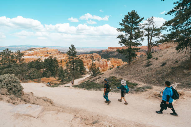 Crowds of hikers make their way up the steep Wall Street trail in Bryce Canyon National Park Utah, USA - May 15, 2021: Hikers make their way down the steep switchbacks on the Queens Garden and Navajo Loop trail in Bryce Canyon National Park escalante stock pictures, royalty-free photos & images