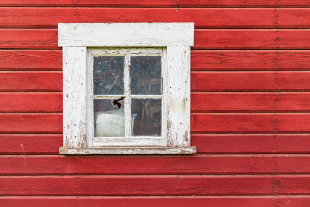 istock Window on the wall of an old red barn. 1330787688
