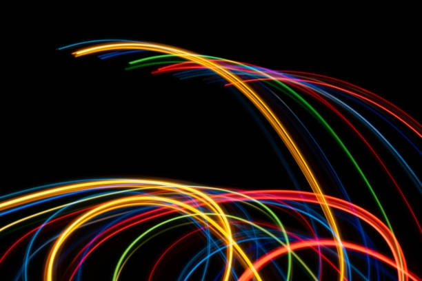 istock colored lines of lights on a black background 1330789377