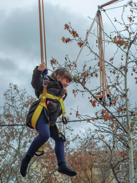 istock Little girl swinging on a rubber band 1330792329