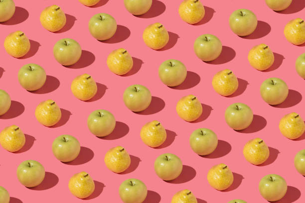 istock Creative pattern made with fresh peaches and pears against pink background. Minimal summer fruit layout. 1330794534