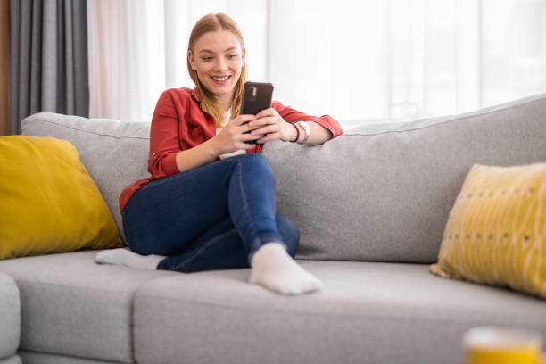 istock Young woman relaxing on sofa at home. 1330797371