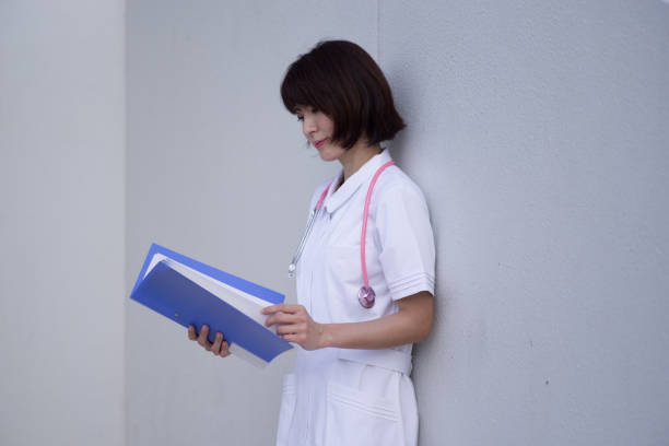Photo of confident lady doctor in blue uniform putting hand in hand isolated purple color background. medicine. the hands of a doctor or nurse