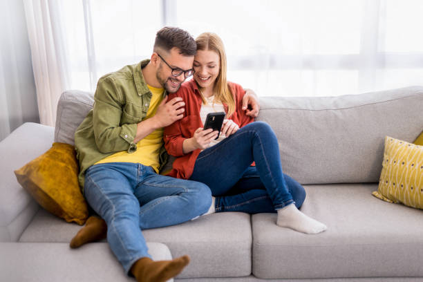 istock Young couple surfing the net on phone at home. 1330797517