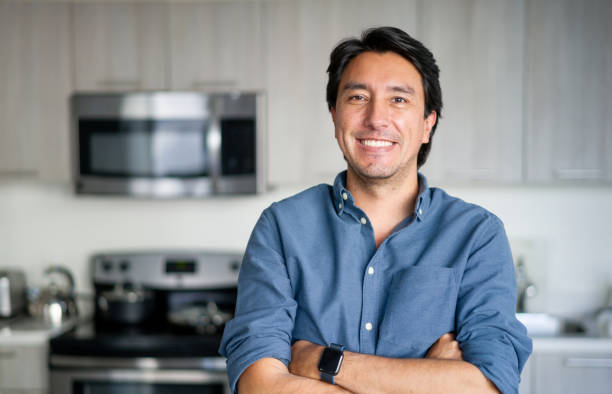 istock Happy Latin American man smiling at home 1330800058