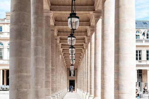 Colonnade / aligned columns in Palais Royal, near Colonnes de Buren, Conseil d’Etat and Conseil Constitutionnel. Paris in France, May 29, 2021.