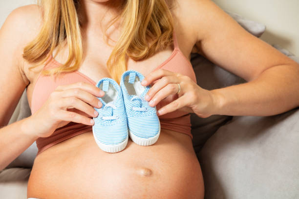 istock Pregnant woman hold small tiny newborn boots 1330807524